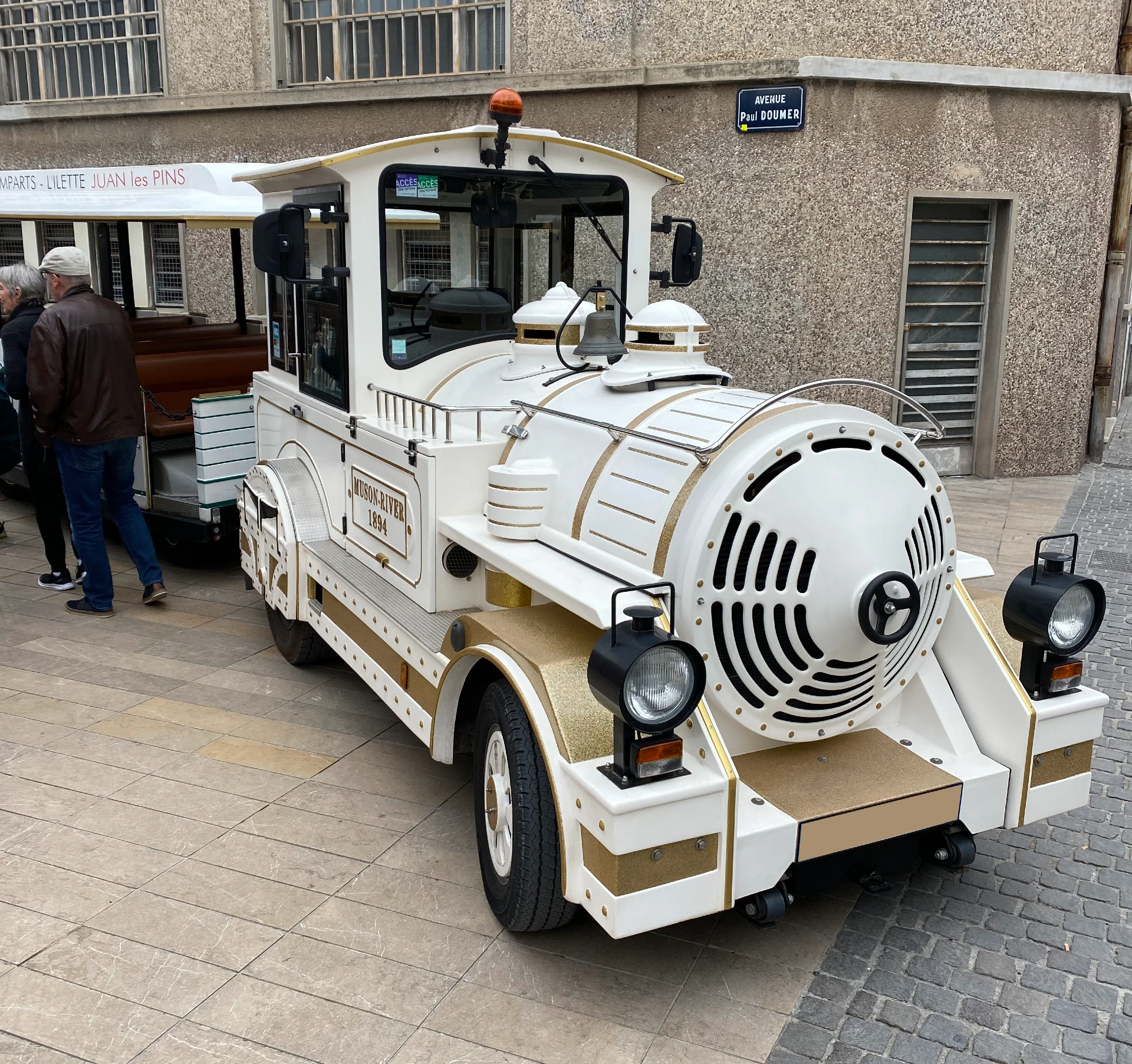 The white and gold locomotive of the Petit Train d’Antibes, three-quarter front view