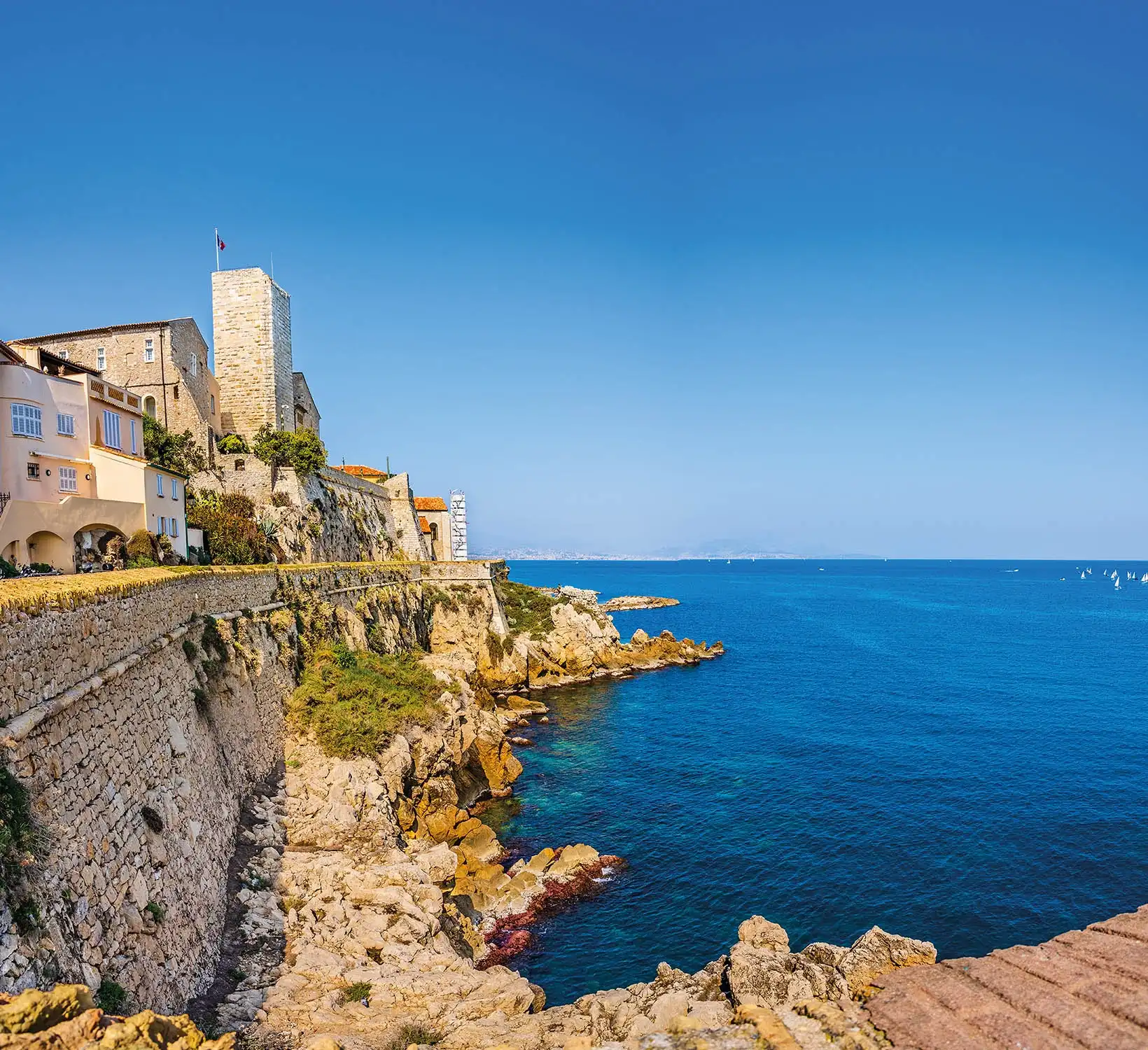 The ramparts of old Antibes above the rocks and the sea